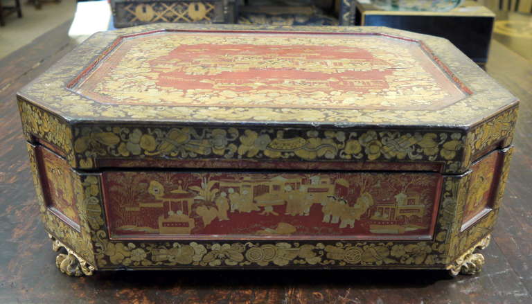 Beautifully detailed 19th century Chinese lacquer lidded box.

The box has a red background, with very detailed gold and black borders featuring landscape and figure design.

Inside the box are smaller boxes, and twelve whimsical trays.  Some of