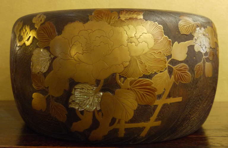 Japanese antique Hibachi carved of Kiri wood, with copper liner and design in bold lacquer on exterior, with mother of pearl.  Design of flowers and vines.