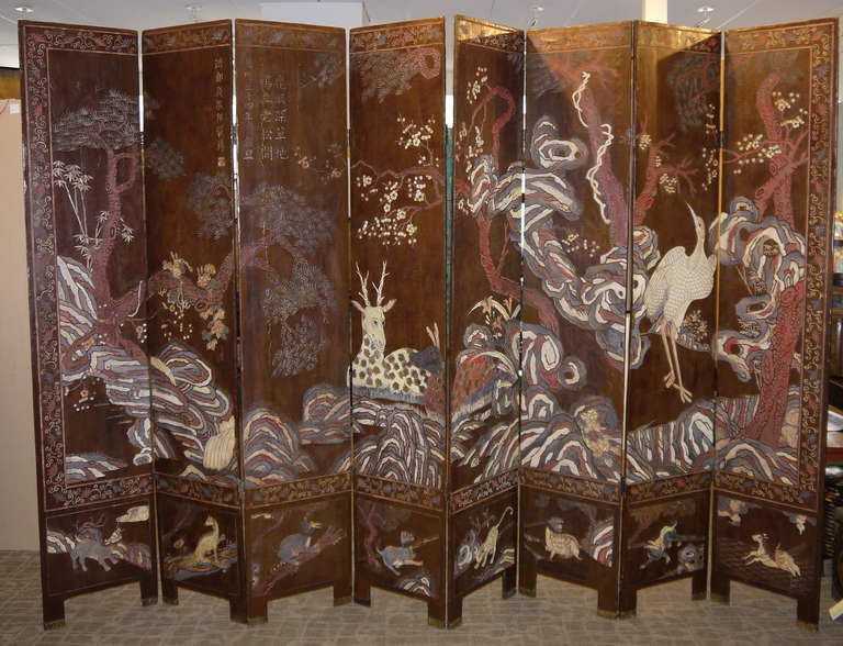 A lovely and interesting Chinese coromandel screen with very different design on both sides.

The first side has ladies in a landscape.   Some are in boats, and some are playing musical instruments among ponds and pavilions.

The reverse has a