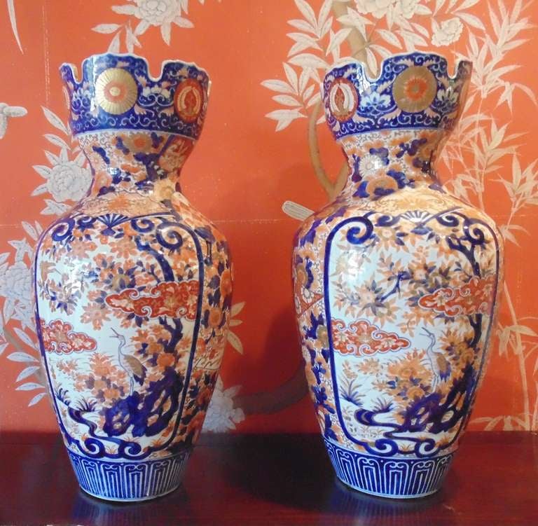 A pair of very large and beautiful Japanese Imari vases with interesting open, fluted rims.

Panels of floral and crane design.