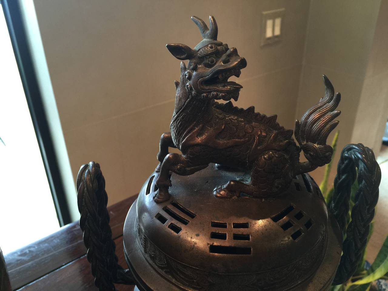An antique bronze censer, Japanese with mythical animal on top.
