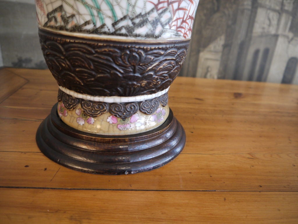 A beautiful pair of Chinese late 19th century crackleware vases with faux bronze bands, floral design, and tops like lotus blossoms.
Bases drilled, and electrified as lamps.
Price includes shades shown.
Vases are 17.75 inches tall. Overall height