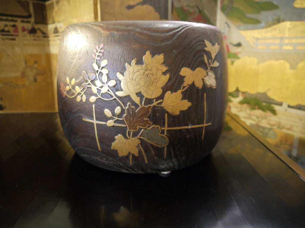 A beautiful antique Japanese wooden hibachi (also called a brazier), with a copper liner.<br />
<br />
This could be used as a planter.<br />
<br />
Made of wood, with inlaid design of fence and flowers on the outside.  The inlay is of lacquer,