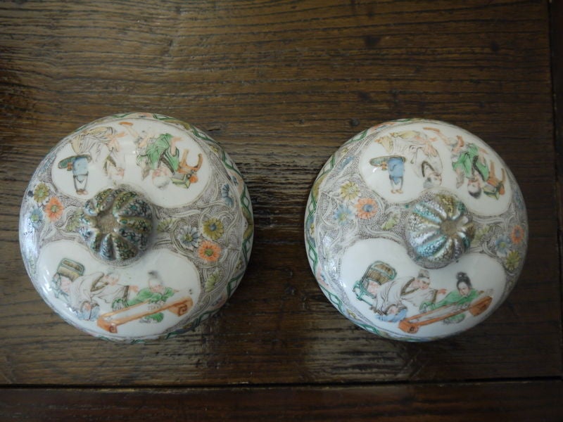 An elegant pair of covered Chinese jars, with covers. Very finely detailed background, in grey, with reserves of landscape and figure design.