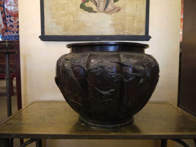 A beautiful large Japanese lobed jardiniere with panels of raised design of flowers and birds.