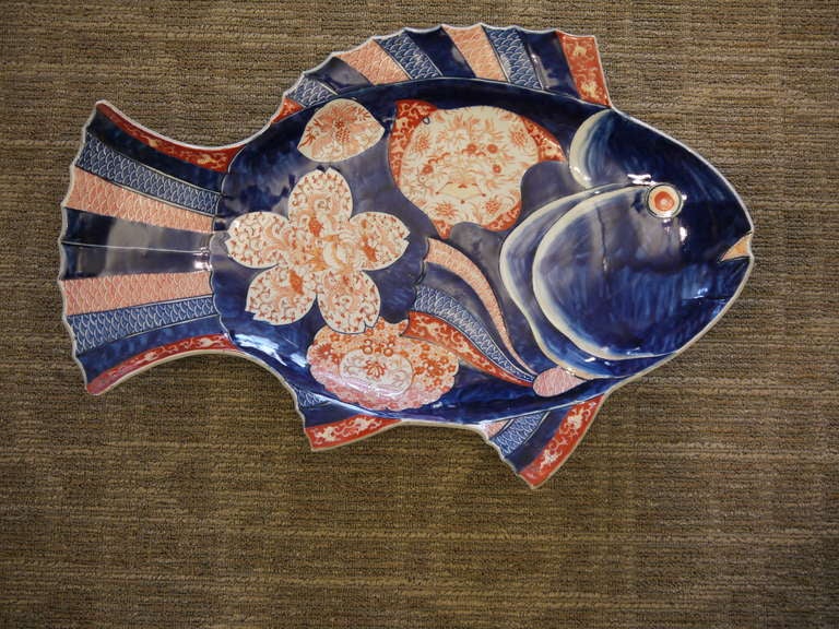 Wonderful large Japanese Imari platter in the shape of a fish, with floral and geometric design.