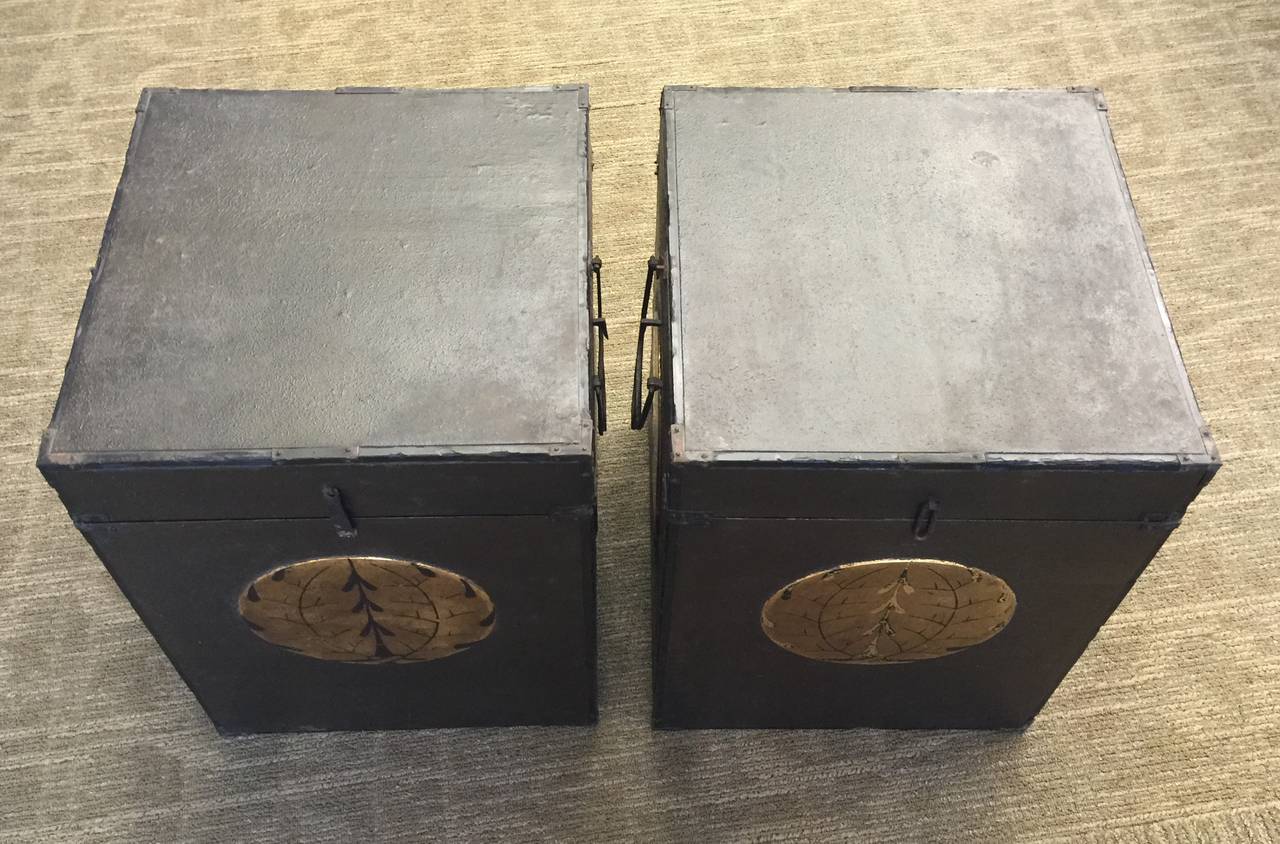A pair of late 18th century or early 19th century storage boxes for a Samurai's armor.  These boxes are covered in leather, and have gold family crests on three sides of each box.

These would make wonderful side tables.