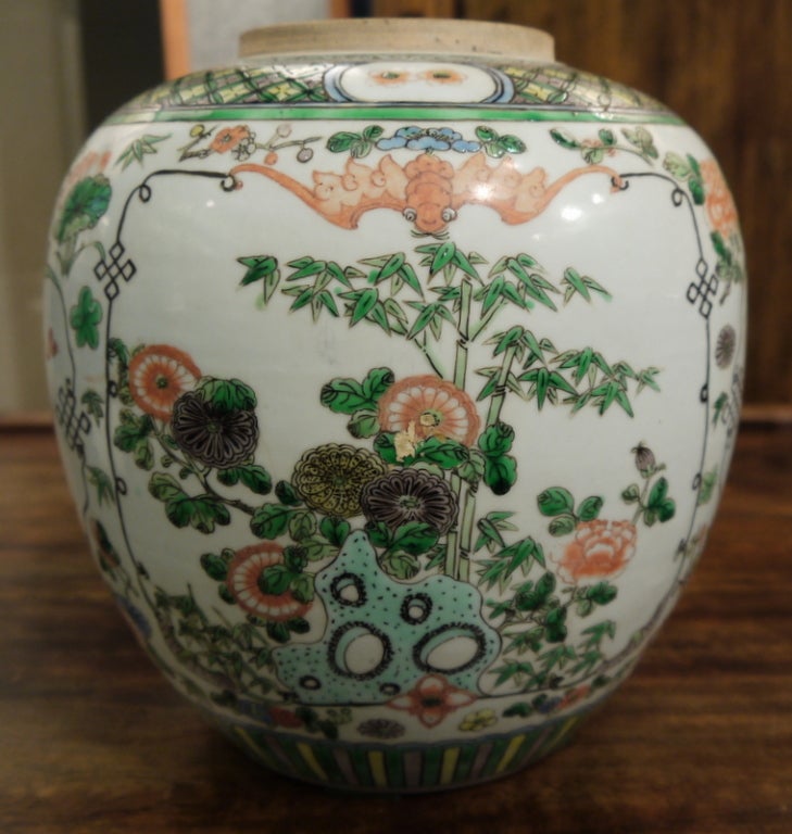 Chinese ginger jar in famille verte tones with blue accents. Panels of floral and antiques design.