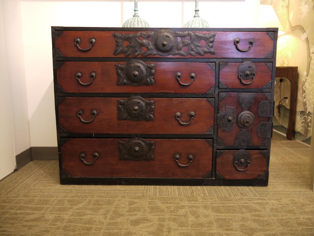 A 19th century Japanese Sendai Tansu chest with six drawers and one door, with drawers inside door.  Metal hardware.