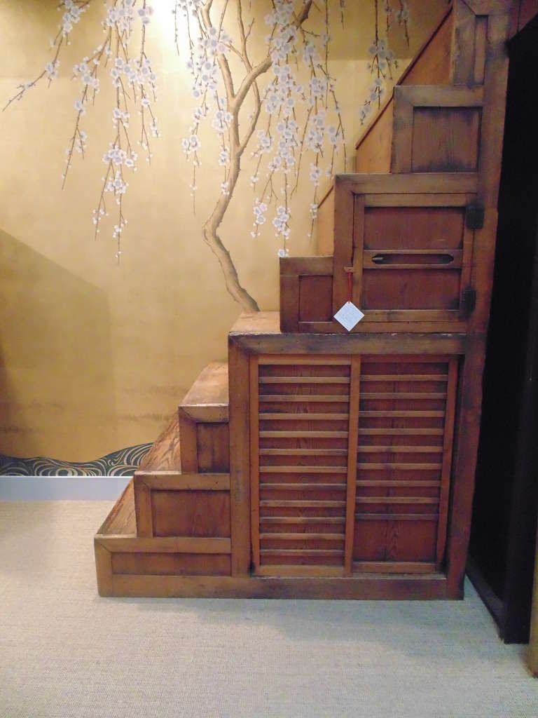 A large late 19th-early 20th century Japanese staircase Tansu, with sliding doors, and eight steps.