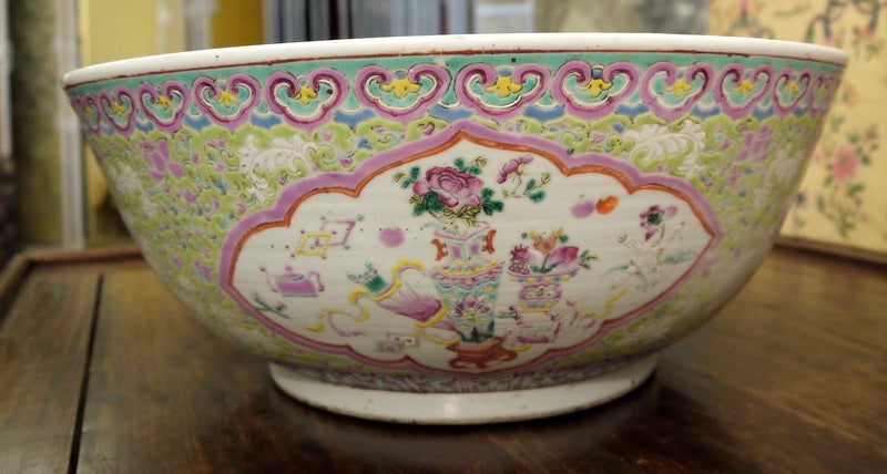 A beautiful, large bowl, with lime green background, famille rose tones and reserves of floral design.

The interior has a bold design of a pond with lilies.

With geometric borders.