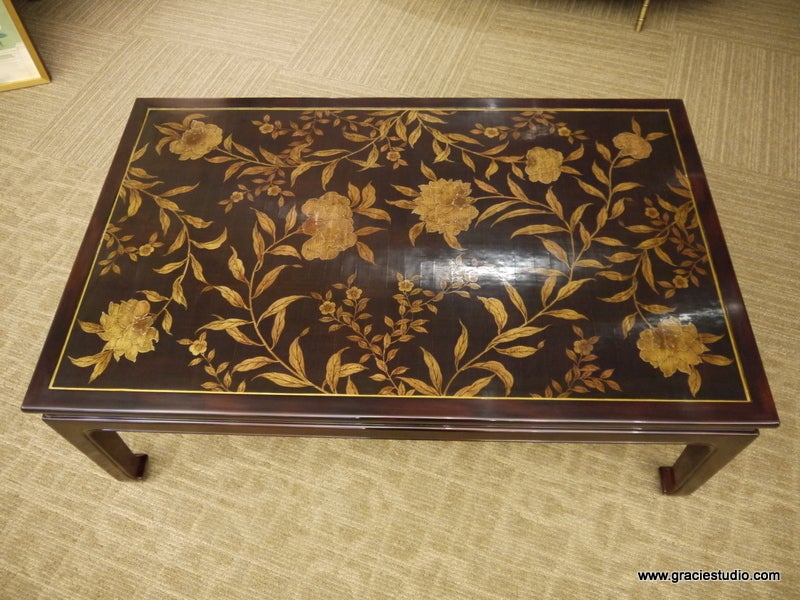 Coffee table with hand-painted floral design in gold, and handmade lacquer finish in very dark brown.