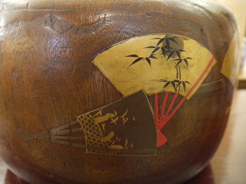 An antique Japanese wooden hibachi with copper liner. Would be great as a planter.

Design on outside of fans in red and gold lacquer, with inlaid mother-of-pearl.