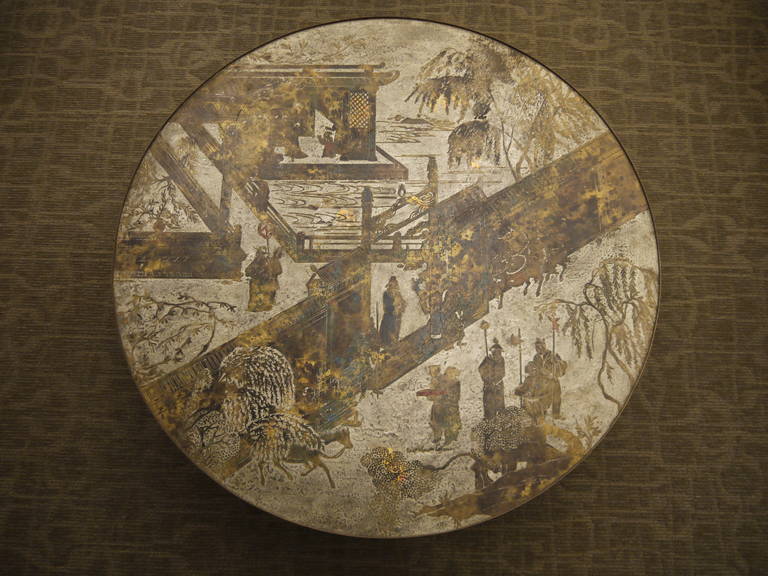 A beautiful round coffee table from the Chan series, by Philip and Kelvin Laverne, circa 1960-1970. This table, featuring a Chinoiserie landscape, sits on a dramatic pedestal base.

As with most Laverne pieces, the base is wood, with etched