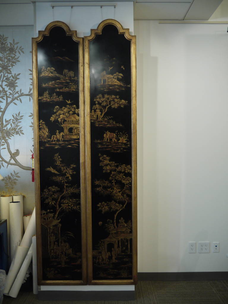 A pair of black lacquer wall panels with gold landscape design, mounted with gold frames.

circa 1970s.