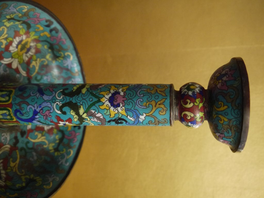 Highly decorative pair of Chinese 19th century blue cloisonne candle stands, with ornate floral and geometric design.