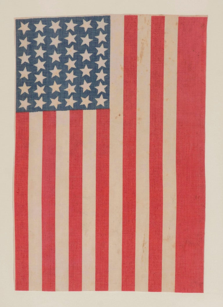 39 STARS, PROBABLY 1876, NEVER AN UNOFFICIAL STAR COUNT, NEVER ACCURATE, SCATTERED STAR POSITIONING:

39 star American national parade flag, printed on cotton muslin. The stars are arranged in a rectilinear fashion, but point in various directions