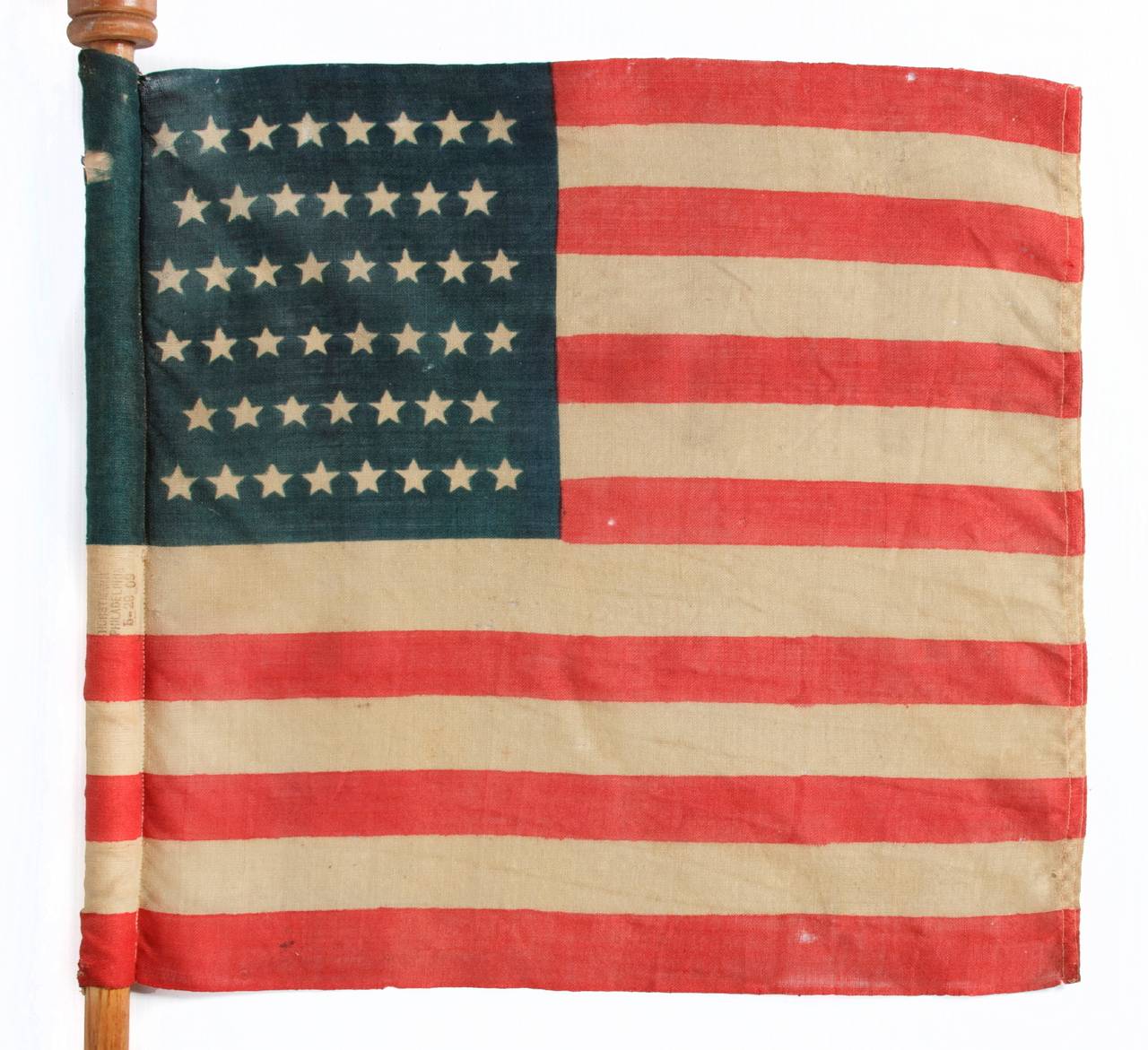 46 STAR U.S. MILITARY CAMP COLORS, PRESS-DYED ON WOOL BUNTING, MADE BY HORSTMANN, PHILADELPHIA, SIGNED AND DATED 1909, ON ITS REMARKABLE, ORIGINAL STAFF:

 American military camp colors are rare in the antiques marketplace. These little flags,
