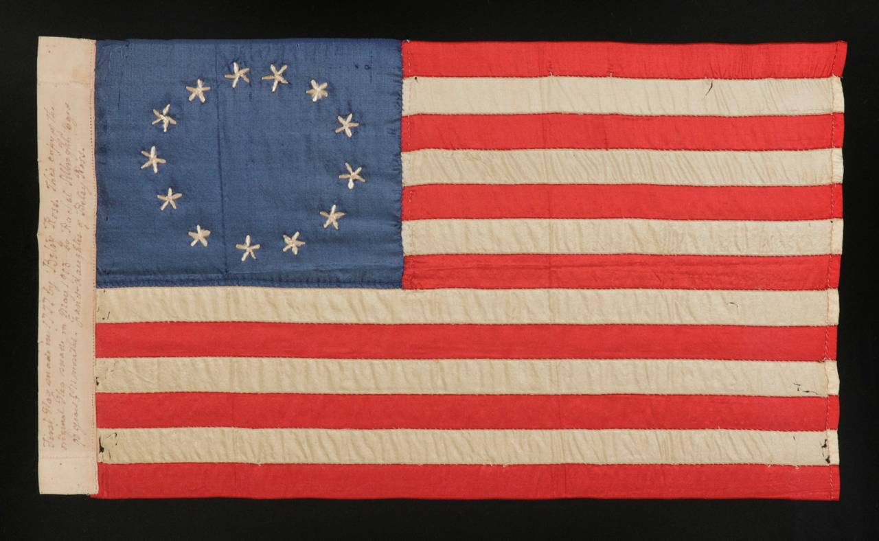 13 hand-embroidered stars and expertly hand-sewn stripes, on a flag made by rachel albright, granddaughter of betsy ross, in philadelphia in 1903, a very large example among its counterparts, with a star configuration that is more oval than