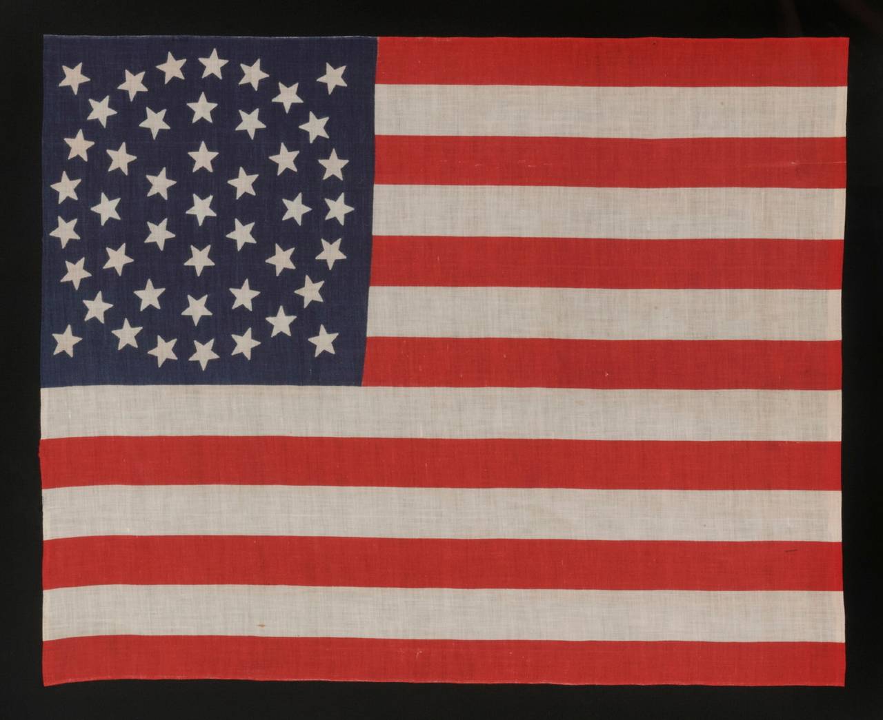 44 stars on a large-scale parade flag, Wyoming Statehood, 1890-1896, rare in this period with a wreath configuration:

44 star American parade flag with triple wreath medallion star configuration, printed on cotton. This highly desired star