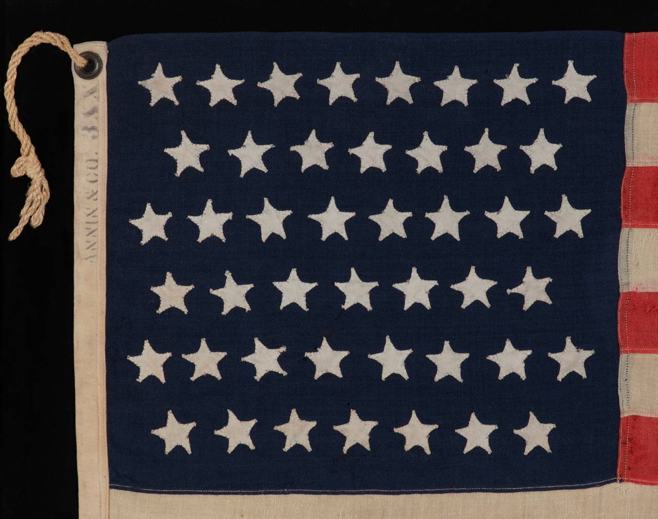 45 hand-sewn, single-appliqued stars on the smallest pieced-and-sewn, commercially-manufactured, wool flag that I have ever encountered in this period, 1896-1908 (Utah Statehood), made and signed by the Annin Company in New York City:

45 star