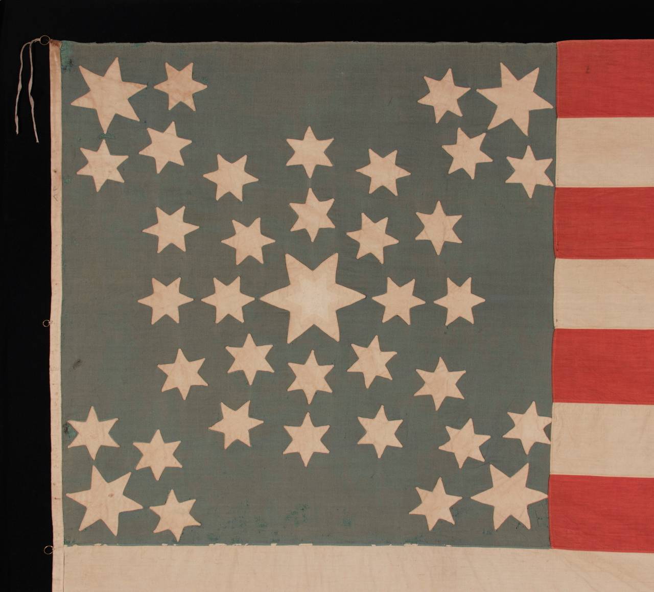 A MASTERPIECE AMONG KNOWN EXAMPLES:
AMAZINGLY GRAPHIC FLAG WITH 37 SIX-POINTED STARS IN A SPECTACULAR DOUBLE-WREATH STYLE MEDALLION, POSSIBLY WITH A PRO-UNION MESSAGE, INSCRIBED WITH THE INITIALS 