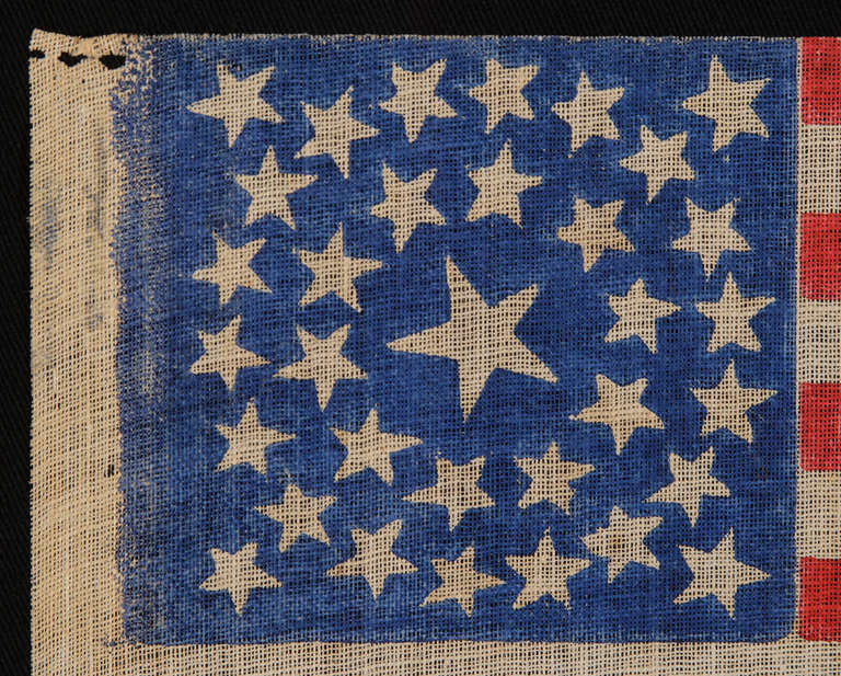 33 STARS, MEDALLION CONFIGURATION, PRE-CIVIL WAR THROUGH WAR PERIOD, 1859-1861:

33 star American national parade flag, printed on coarse, glazed cotton. The stars are arranged in a double wreath pattern with a large center star and 4 flanking