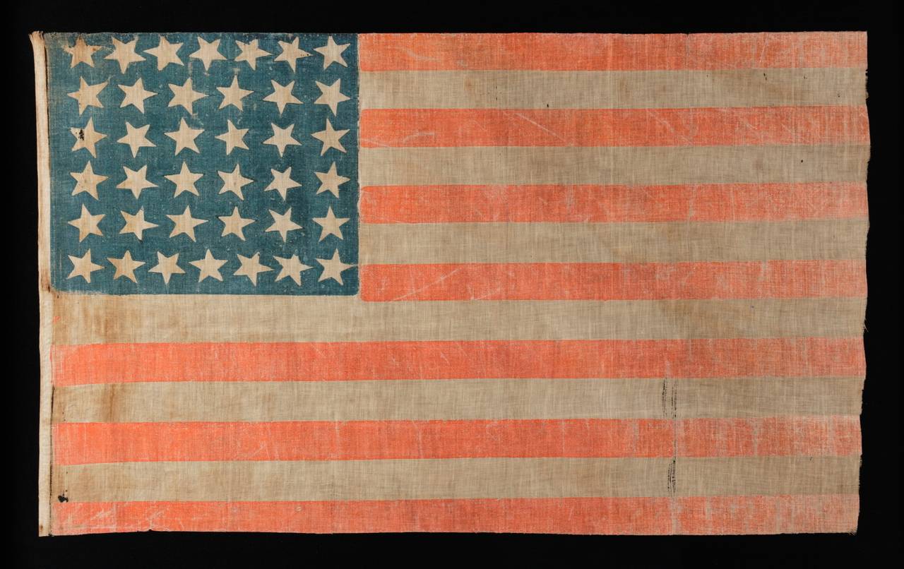38 LARGE STARS WITH SCATTERED POSITIONING ON A LARGE SCALE PARADE FLAG, COLORADO STATEHOOD, 1876-1889:

38 star American national parade flag, printed on coarse, glazed cotton. Note how the stars are arranged in justified rows of 7-6-6-6-6-7 and