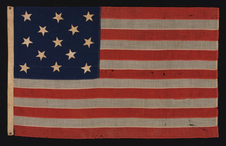 13 star American national flag of the type flown by the U.S. Navy in the 1870-1880's period. Because the Navy's flags of this era were made in the same fashion as many of those produced for private use in cottage industry settings, it can be