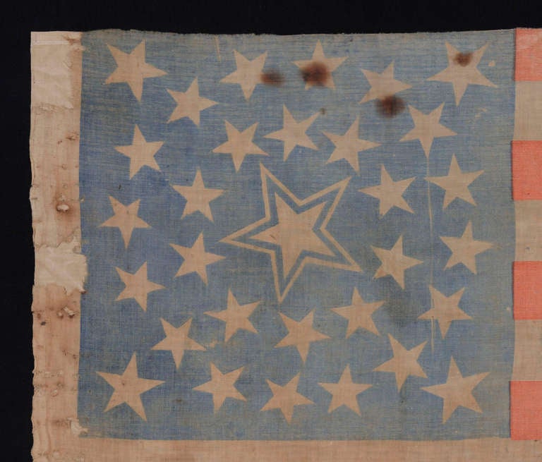 31 STARS, PRE-CIVIL WAR (1850-1858), CALIFORNIA STATEHOOD, MEDALLION CONFIGURATION WITH A LARGE, HALOED CENTER STAR:

31 star American national flag, printed on cotton, with a medallion configuration of stars. This consists of a large center star,
