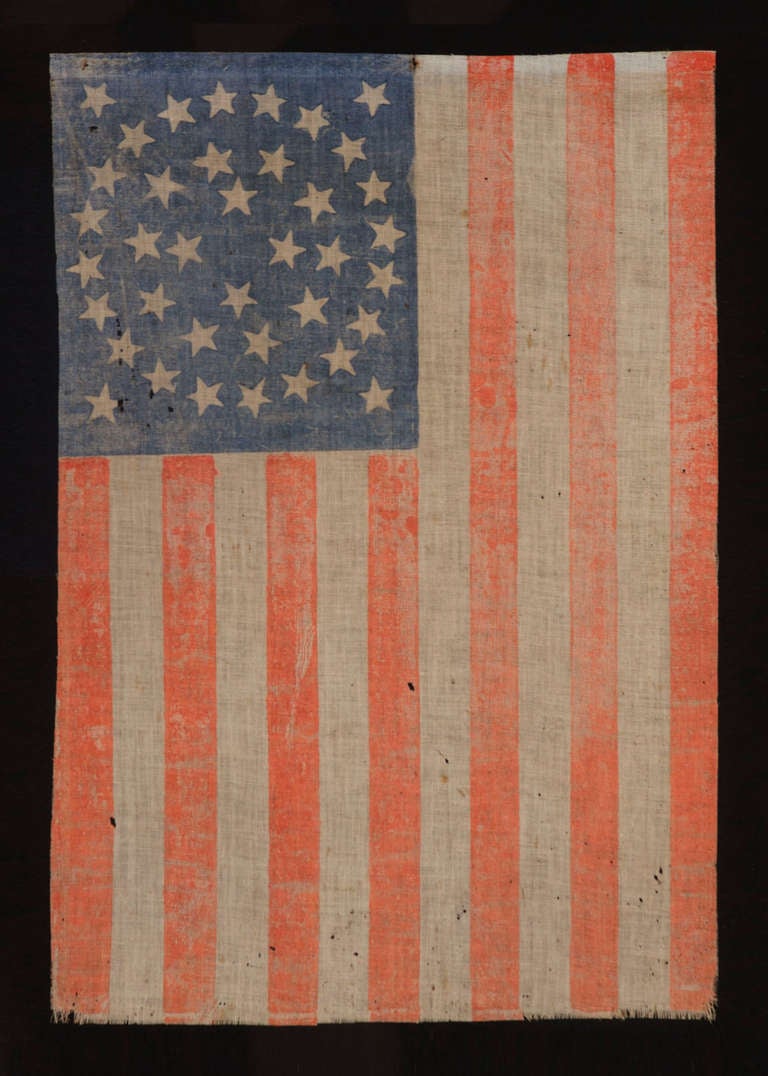 38 STARS IN AN EXTREMELY RARE VARIANT OF THE MEDALLION CONFIGURATION THAT HAS A DIAMOND OF STARS IN THE CENTER, COLORADO STATEHOOD, 1876-1889:

38 star American national parade flag, printed on coarse, glazed cotton. The stars are arranged in a