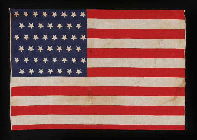 45 UPSIDE-DOWN STARS, 1896-1907, UTAH STATEHOOD, SPANISH-AMERICAN WAR ERA: 

45 star American parade flag, printed on cotton. The stars are arranged in staggered rows and are upside-down in their vertical alignment (with two points up instead of