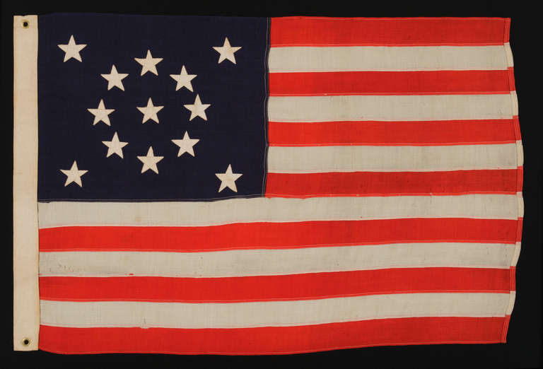13 STARS ARRANGED IN A MEDALLION PATTERN ON A SMALL-SCALE FLAG OF THE 1890's:

 13 star flag of the type that commercial flag-makers began to produce during the last decade of the 19th century. The stars are arranged in a beautiful medallion