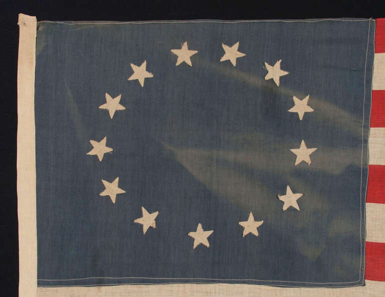 13 STARS IN THE BETSY ROSS PATTERN, A VINTAGE, HOMEMADE, MAKE-DO FLAG OF THE 1926-1945 PERIOD: 

 This 13 star American national flag was fabricated by a person who wished to have something in the original star count for a patriotic celebration.