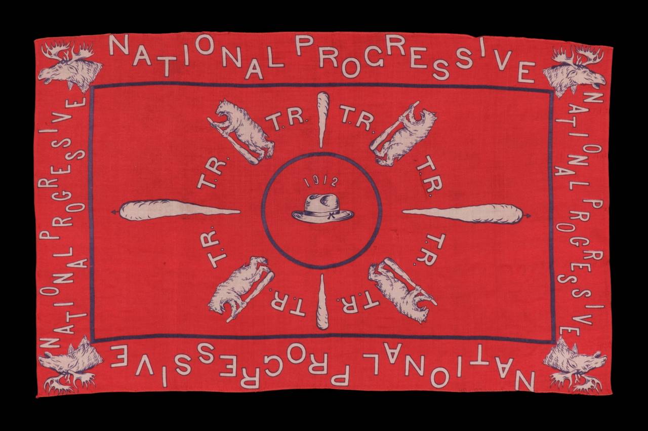 SILK CAMPAIGN KERCHIEF IN AN UNUSUAL, HORIZONTAL FORMAT, MADE TO PROMOTE THE 1912 PRESIDENTIAL RUN OF TEDDY ROOSEVELT, WHEN HE RAN ON THE NATIONAL PROGRESSIVE PARTY “BULL MOOSE” TICKET:

 Bull moose heads, large clubs, and standing bears wielding