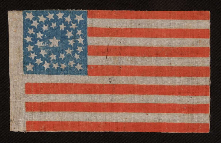 35 STAR ANTIQUE AMERICAN PARADE FLAG WITH DOUBLE WREATH STYLE MEDALLION STAR CONFIGURATION, 1863-1865, WEST VIRGINIA STATEHOOD:

 34 star American parade flag, printed on coarse, glazed cotton. The stars are arranged in what is known as a