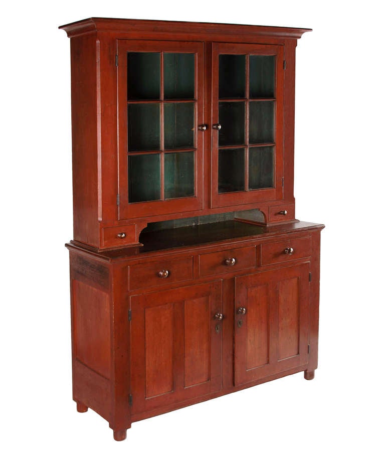 PENNSYLVANIA OR OHIO DUTCH CUPBOARD IN CHERRY, ON MILK BOTTLE FEET, WITH A STRONG, TOMATO RED WASH, BLUE PAINTED INTERIOR, AND INDLAID KNOBS, CA 1835:

 Solid cherry Dutch cupboard with a strong, Tomato red wash, made ca 1835. The two-piece case