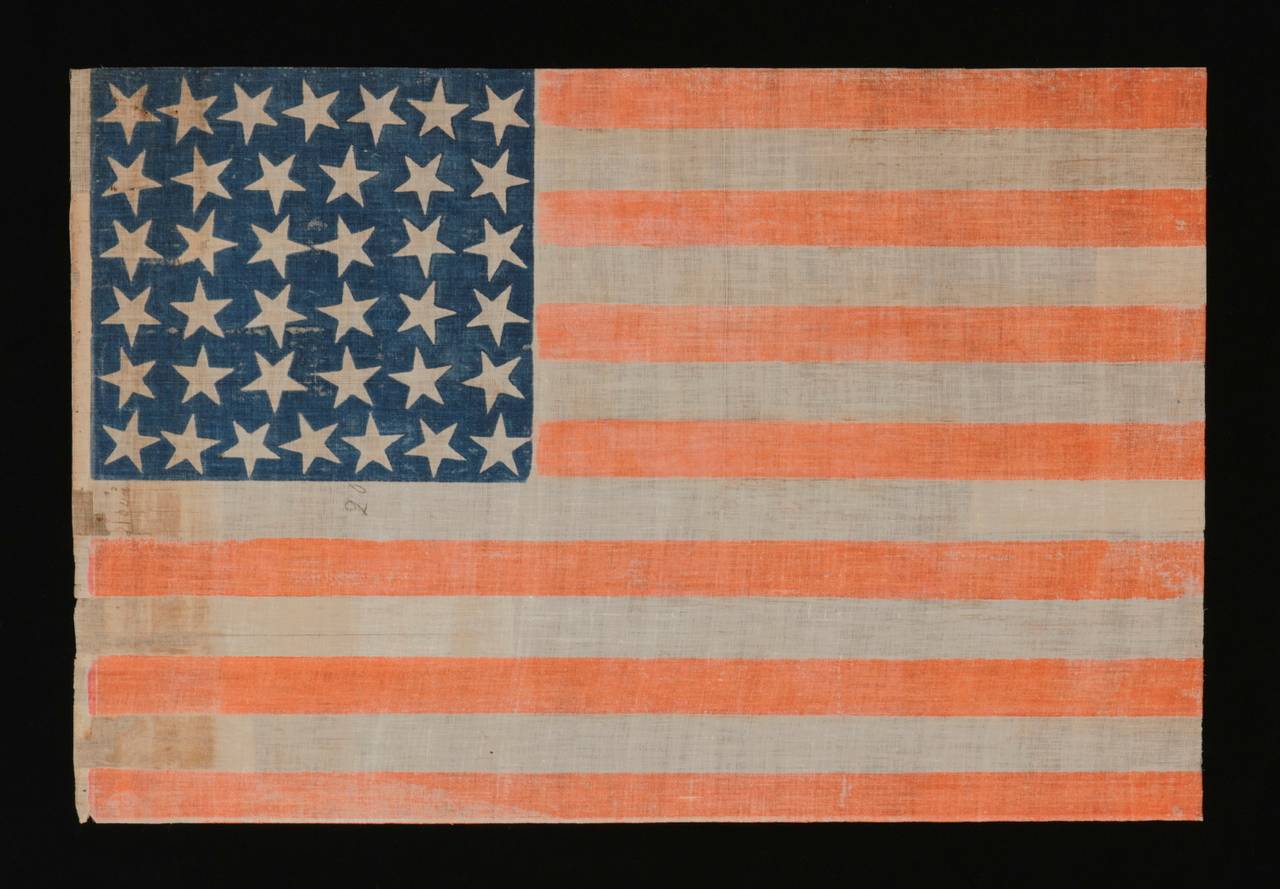 38 large stars with scattered positioning on a large scale parade flag, Colorado statehood, 1876-1889:

 38 star American national parade flag, printed on coarse, glazed cotton. Note how the stars are arranged in justified rows of 7-6-6-6-6-7 and