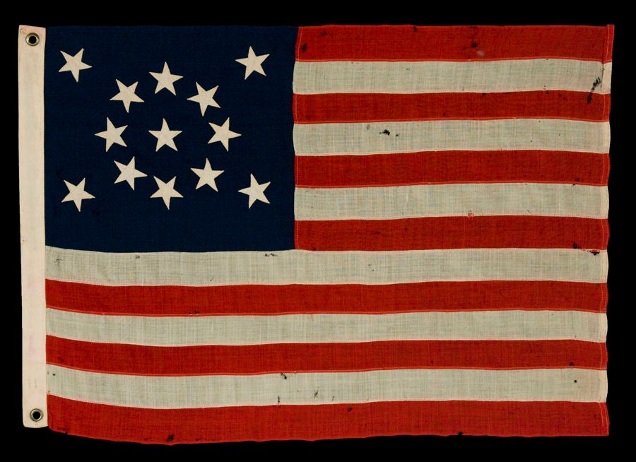 13 STARS IN A MEDALLION CONFIGURATION ON A SMALL-SCALE FLAG