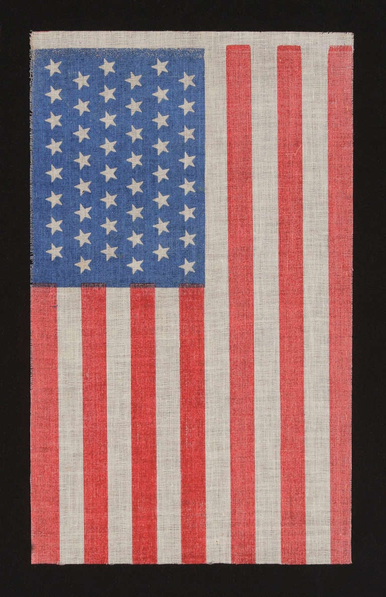 48 STARS IN STAGGERED ROWS ON A ROYAL BLUE CANTON, AN UNOFFICIAL CONFIGURATION FOR THIS STAR COUNT, 1912-1918:

48 star American national parade flag, printed on coarse glazed cotton. The stars of the flag are arranged in staggered rows, which was