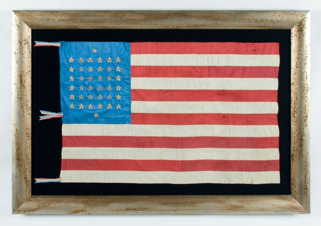 38 STAR, SILK FLAG WITH 12 STRIPES AND THREE DIFFERENT STYLES OF <br />
HAND-EMBROIDERED STARS, ARRANGED TO REFLECT THE NUMBER OF NORTHERN AND SOUTHERN SUPPORTING STATES DURING THE CIVIL WAR, AND RESULTING IN ONE OF THE MOST RARE STAR