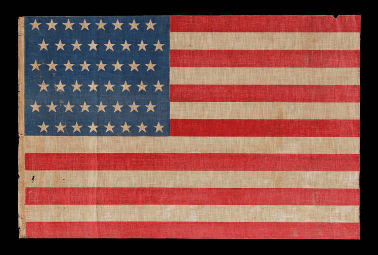 48 Star Parade Flag in a Staggered Row Pattern, on a Cornflower Blue Canton, 1896-1918: 48 star American national parade flag, printed on coarse cotton, with an attractive, cornflower blue canton and scarlet red stripes.

The 48 star flag became