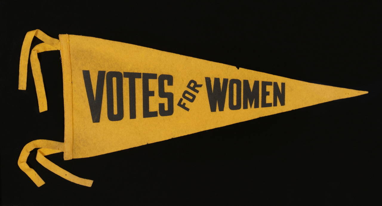 Triangular suffragette pennant with text that reads: 