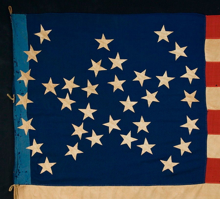 34 STARS IN A UNIQUE “GREAT STAR” PATTERN, FLANKED BY ARCHED BRACKETS, CIVIL WAR PERIOD, 1861-63, SEEMINGLY OF PROVENCETOWN MASSACHUSETTS ORIGIN:

34 star American national flag of the Civil War period, with a strikingly beautiful variation of