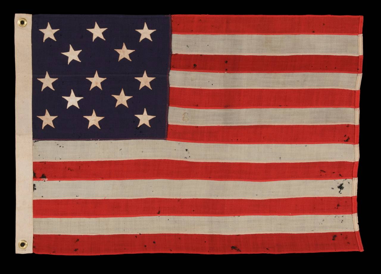 13 STARS ARRANGED IN A 3-2-3-2-3 LINEAL CONFIGURATION ON A SMALL-SCALE ANTIQUE AMERICAN FLAG MADE DURING THE FIRST HALF OF THE 1890's:

 This 13 star antique American flag is of the type made during the last decade of the 19th century through the