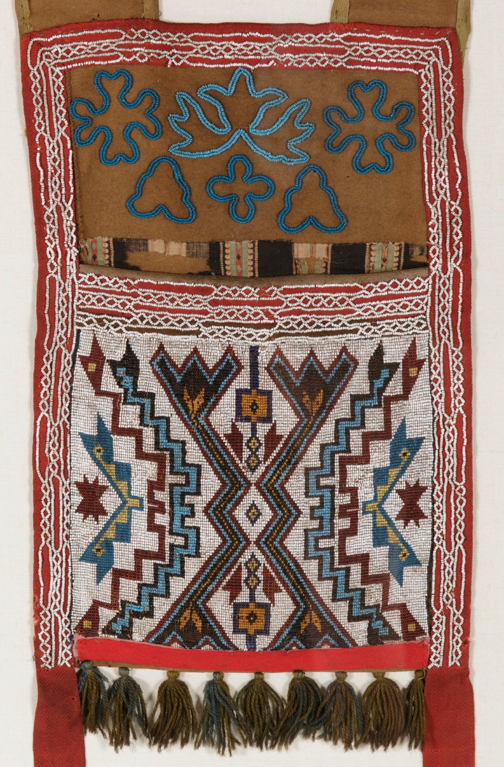 BEADED, NATIVE AMERICAN BANDOLIER BAG, WITH GEOMETRIC AND FLORAL PATTERNS, CHIPPEWA OR WINNEBAGO INDIAN NATION, circa 1880:

Beaded, native American, bandolier bag, made ca 1880.  The layout and designs utilized I would attribute as being of