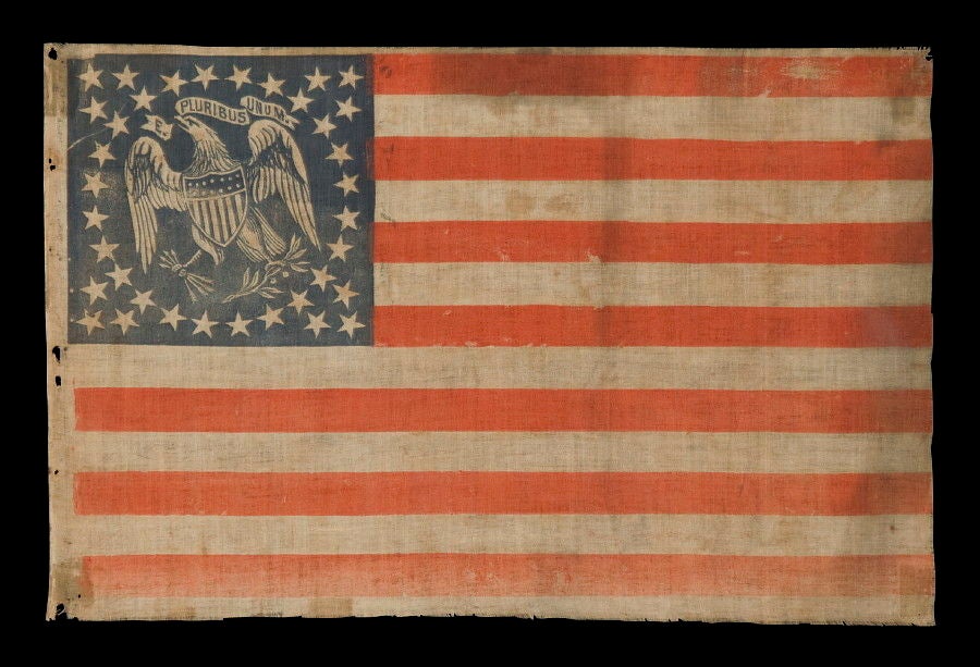 EXTREMELY RARE PARADE FLAG WITH 36 STARS ANDAN EAGLE IN THE CANTON, AN IMPORTANT, UNDOCUMENTED EXAMPLE AND THE ONLY ONE OF ITS KIND KNOWN TO EXIST IN THIS STAR COUNT:<br />
<br />
36 star American National parade flag, printed on cotton. In the