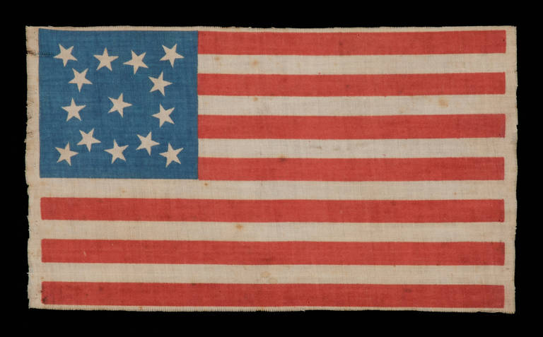 14 STARS, 1876, A SCARCE EXAMPLE WITH A MEDALLION CONFIGURATION AND POSSIBLE VERMONT ASSOCIATION:

 14 star American national parade flag, printed on cotton. The stars are arranged in a medallion configuration that consists of a wreath of 9 stars,