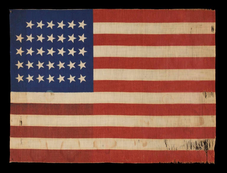 34 STARS, CIVIL WAR PERIOD, PRINTED ON A WOOL BLENDED FABRIC, RARE NOTCHED DESIGN WITH TILTED STARS, POSSIBLY A UNION ARMY CAMP COLORS:

 34 star American national flag, printed on a wool and cotton blend. The star configuration, which leaves a