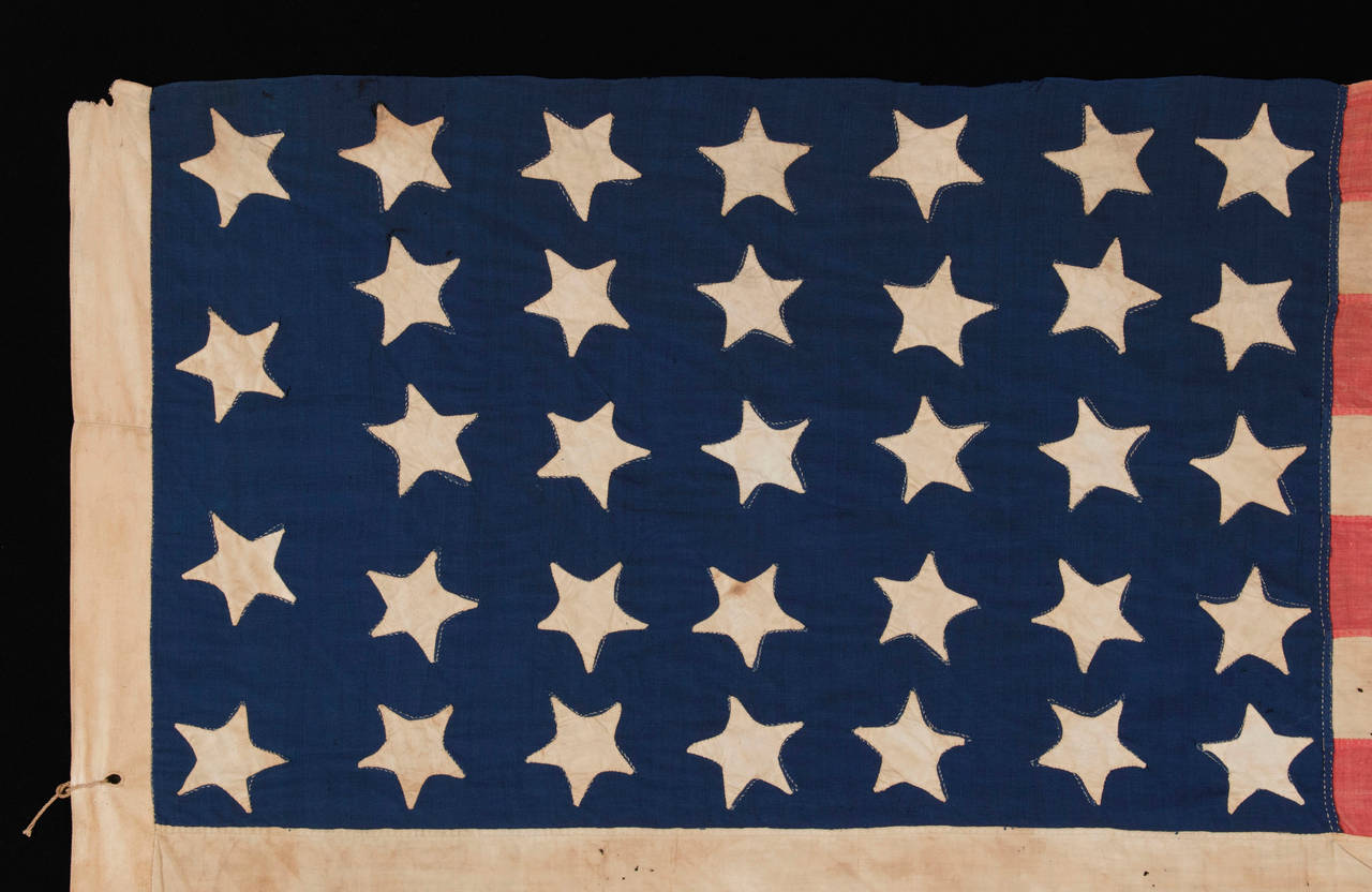 34 STARS, AN ENTIRELY HAND-SEWN CIVIL WAR PERIOD FLAG IN AN EXTRAORDINARY SMALL SIZE FOR THE PERIOD, 1861-63, KANSAS STATEHOOD: 

 34 star American national flag of the Civil War period, entirely hand-sewn and in an unusually small size among its